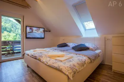 a bedroom with a bed in a room with a window at Apartments Perla in Zgornje Gorje