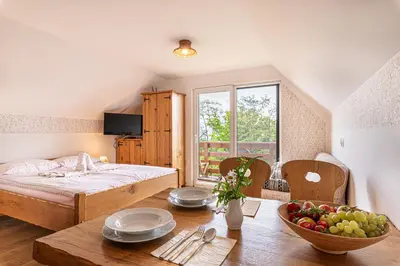 a bedroom with a bed and a table with a bowl of fruit at Vineyard Cottage Rataj 2 in Novo Mesto