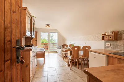 a kitchen and dining room with a table and chairs at Vineyard Cottage Rataj 2 in Novo Mesto