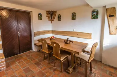 a dining room with a wooden table and chairs at Vineyard Cottage Rataj 2 in Novo Mesto