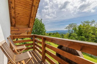 a deck with two chairs and a view at Vineyard Cottage Rataj 2 in Novo Mesto