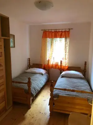 a bedroom with two beds and a window at Holiday house Pr Robč in Bovec