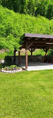 a picnic shelter in a park with green grass at Holiday house Pr Robč in Bovec