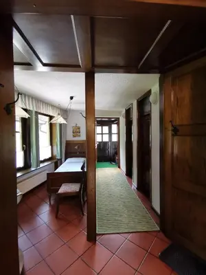 a hallway with a room with a bed and a table at Apartmaji Mak in Jesenice