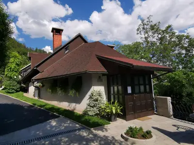 a house with a brown roof and a garage at Apartmaji Mak in Jesenice