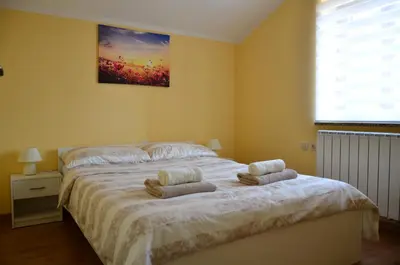a bedroom with a bed with two towels on it at Apartma Louis in Dutovlje