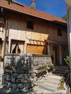 a house with a fence in front of it at pr' Drašlerju in Dovje