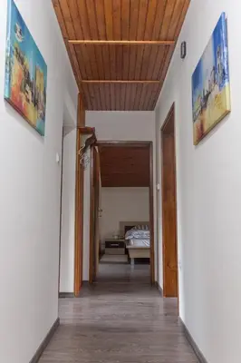 a hallway leading to a bedroom with a bed at Hanzi Holiday Home in Rečica ob Savinji