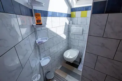 a bathroom with a toilet and a sink at Bled Honey Bee Apartment in Bled