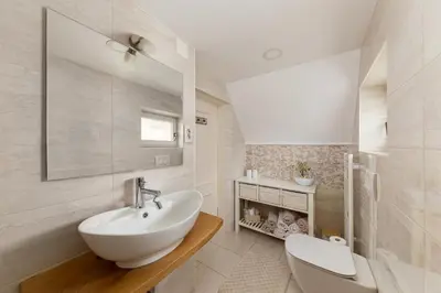 a white bathroom with a sink and a toilet at Apartma Summer Garden in Bled