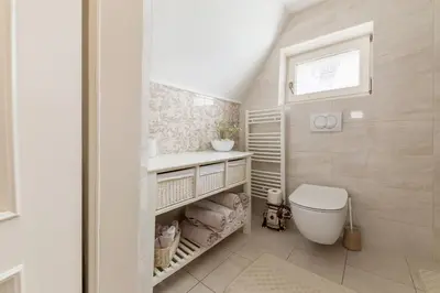 a bathroom with a toilet and a sink at Apartma Summer Garden in Bled