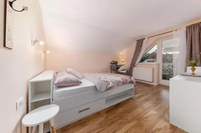 a small bedroom with a bed and a window at Apartma Summer Garden in Bled