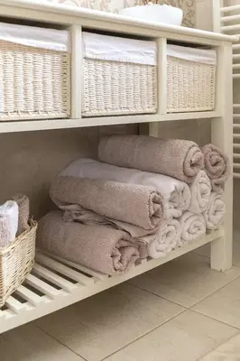 a pile of towels on a shelf in a bathroom at Apartma Summer Garden in Bled