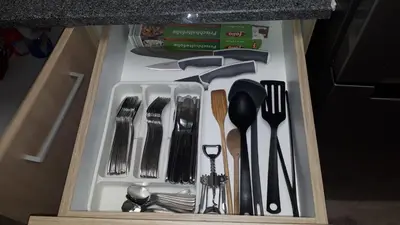 a drawer filled with utensils in a drawer at Tabor - Apartments Rozmanova Street in Ljubljana