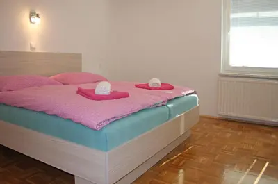 a bed with two hats and towels on top of it at Apartment Ravnik Brod 13 in Bohinj