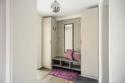 a dressing room with a bench and a mirror at Apartments Villa Tatiana in Bled