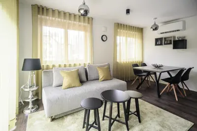 a living room with a couch and a table at Apartments Villa Tatiana in Bled