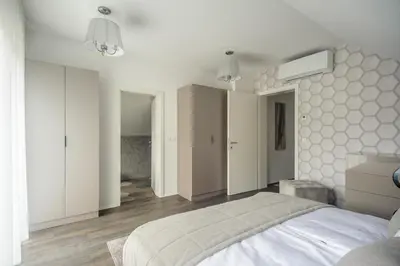 a bedroom with a large white bed in it at Apartments Villa Tatiana in Bled