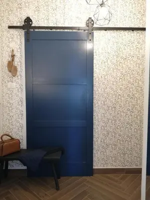 a blue garage door in a room with a bench at MAPLE place in Pivka