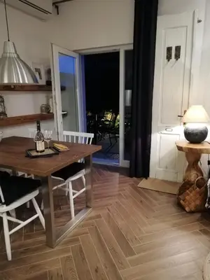 a living room with a wooden table and a dining room at MAPLE place in Pivka