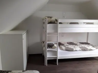 a bunk bed room with two bunk beds in a attic at Simnovi apartmaji - surrounded by nature in Kamnik