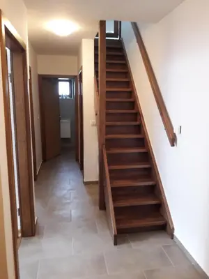 a hallway with stairs in a house at Simnovi apartmaji - surrounded by nature in Kamnik