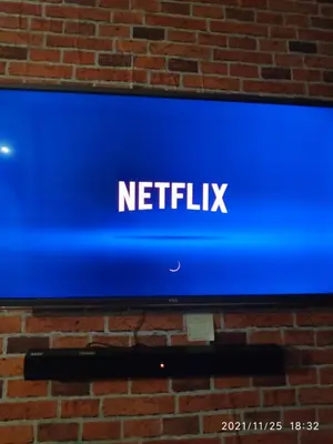 a sign that says netflix on a brick wall at Apartment GREEN&URBAN in Celje