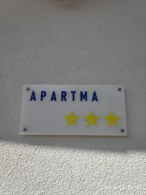 a sign on a wall with four stars on it at Apartment GREEN&URBAN in Celje