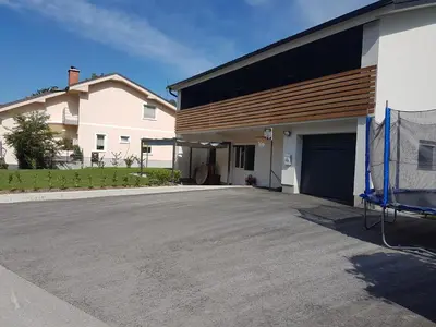 a driveway in front of a house with a garage at Apartment GREEN&URBAN in Celje