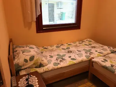 a small bedroom with a bed and a window at APARTMA SABOTIČ in Sedula
