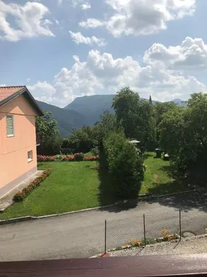 a view of a yard with trees and a house at APARTMA SABOTIČ in Sedula