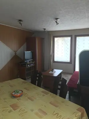 a room with a table and a television and a table and chairs at APARTMA SABOTIČ in Sedula