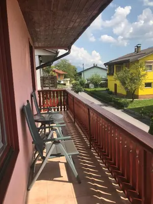 a pair of chairs sitting on the balcony of a house at APARTMA SABOTIČ in Sedula