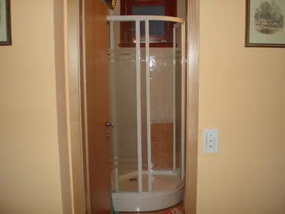 a shower with a glass door in a bathroom at APARTMA SABOTIČ in Sedula