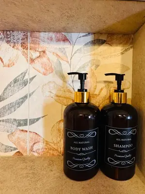 two bottles of soap sitting next to each other at Enam Room in Kojsko