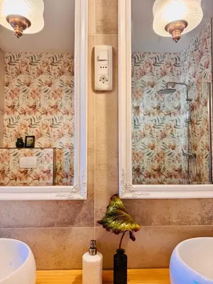 a bathroom with two sinks and a large mirror at Enam Room in Kojsko