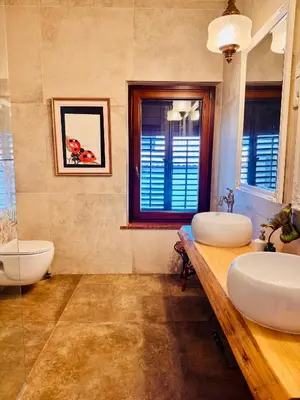 a bathroom with two sinks and a tub at Enam Room in Kojsko