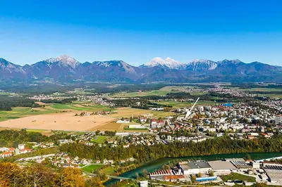 an aerial view of a town with mountains in the background at Goldenfields apartment in Kranj