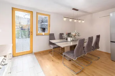 a kitchen and dining room with a table and chairs at Bohinj Cottage Pr' Maricki - house in nature with hot tub & sauna in Bohinj