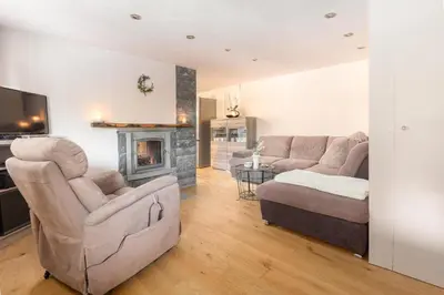 a living room with a couch and a fireplace at Bohinj Cottage Pr' Maricki - house in nature with hot tub & sauna in Bohinj