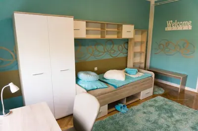 a childs bedroom with a bunk bed and a dresser at Trendy apartmant in city in Maribor