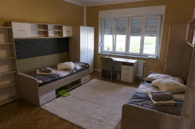 a bedroom with two bunk beds and a desk at Trendy apartmant in city in Maribor
