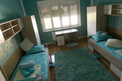 a small room with two bunk beds and a desk at Trendy apartmant in city in Maribor