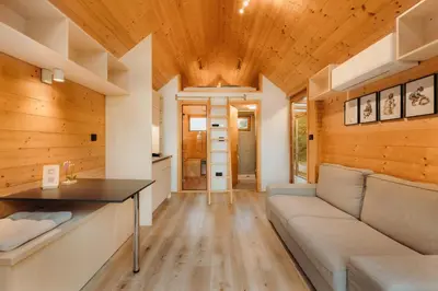a living room with a couch and a table at Glamping Mountain Fairy Tale in Bistrica pri Tržiču
