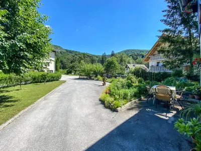 an empty road with a house and a table and chairs at Apartment Ticar in Bohinj