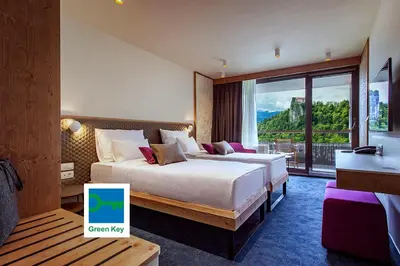 a hotel room with two beds and a window at Hotel Park - Sava Hotels & Resorts in Bled