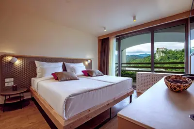 a bedroom with a bed and a large window at Hotel Park - Sava Hotels & Resorts in Bled