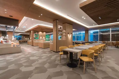 a restaurant with tables and chairs in a room at Rikli Balance Hotel – Sava Hotels & Resorts in Bled
