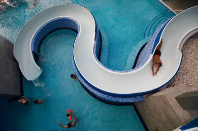 a group of people in a pool with a toilet in the water at Rikli Balance Hotel – Sava Hotels & Resorts in Bled