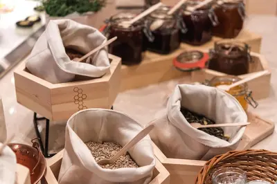 a table topped with three boxes of food with packets of grains at Rikli Balance Hotel – Sava Hotels & Resorts in Bled